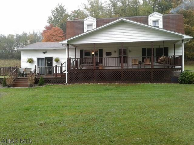 Beautiful inside and out.  Enjoy privacy in this cozy,very well maintained, spacious, 4 bedroom, 2 bath home situated on a large 2.4 acre lot.  Plenty of space for family gatherings, hardwood floors, large covered front porch, deck and eat in kitchen.  Priced to sell.