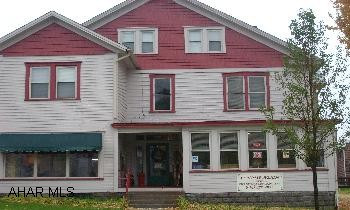 2 aptartments currently rented, First Floor is consignment shop that is available for sale at an additional cost. Call LOUANN for details Great Commercial Location 2 rented apartments PLUS  store frontCall Louann to set up showingsWould be great for the investor, huge building with many possibilities. Second floor needs to be finished. Large parking lot in rear.
