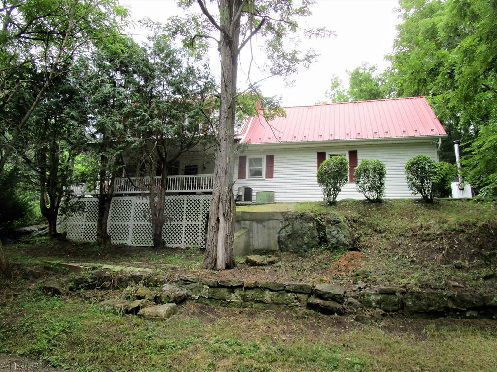 This farmette is perfect for the horse lover, hobby farmer, or just living your country dream!! Two-story home with 3-bedrooms, 2.5 baths, kitchen with granite counters,office/den, great room with cathedral ceiling, living room, dining room. Pine board floors throughout, oil hot water heat, outdoor wood furnace, and central air-conditioning.  Barn, over-sized four-car garage that will accommodate large trucks or RV's with 16' ceilings, sheds, carport and a 50' x 72' pole building. Resting on 13.33 acres mostly wooded acres with a stream. Peaceful property only minutes from town but secluded!!