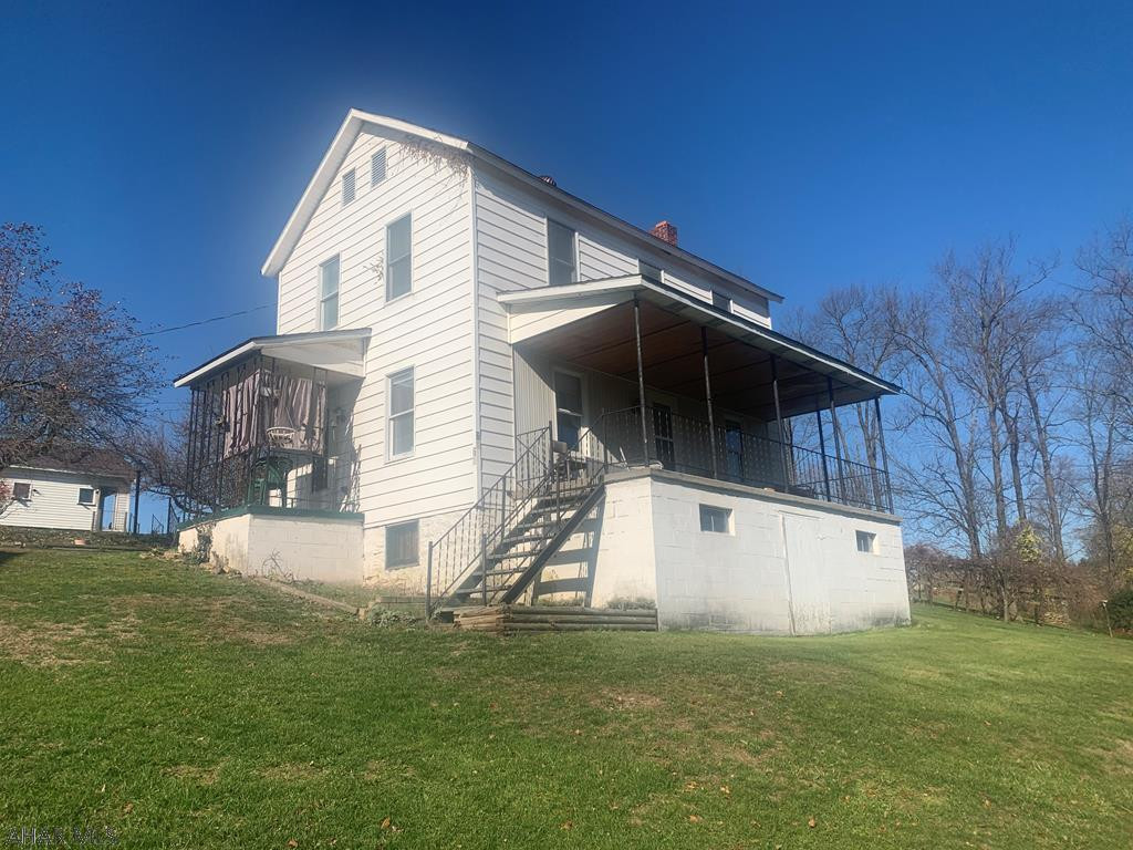 Partially remodeled home on a large lot featuring 3 bedrooms and a bath, living room and oak kitchen cabinets. Nice view from the front porch.  Two car detached garage.  Estate sale.