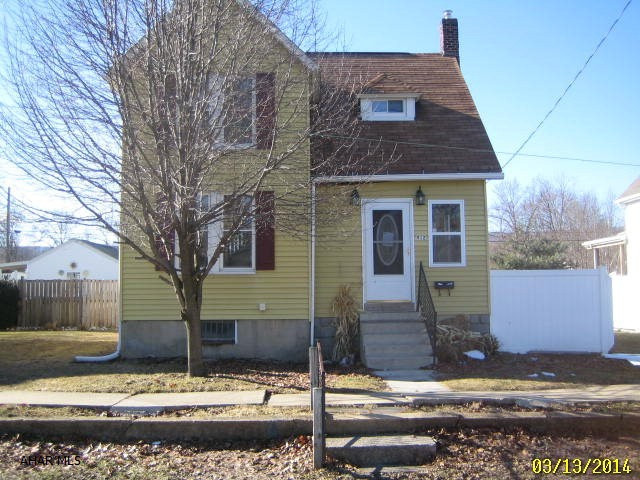 Large 2 story vinyl Bellwood home with large, level lot and oversized 1 car garage. Large living room, formal dining, family room and eat-in kitchen. First floor laundry and bath. Some updates throughout, but needs some TLC.  Being sold AS-IS. Seller will make no repairs.