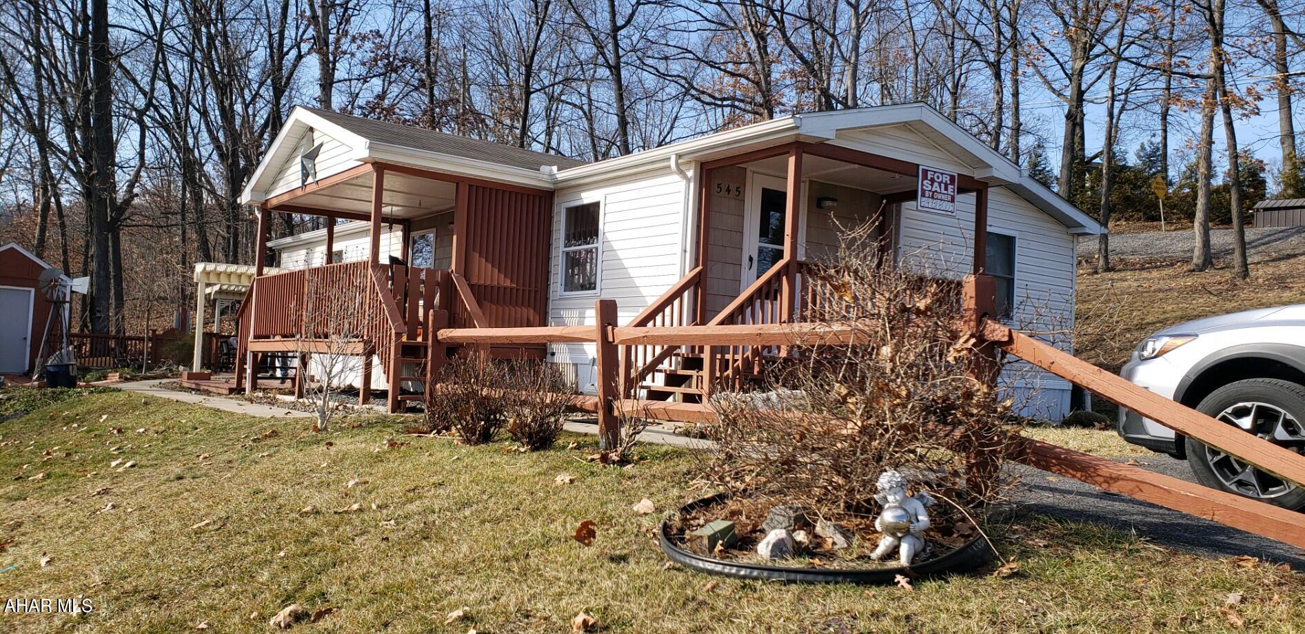 This immaculate home has been re-finished with dry wall, newer flooring, tile, and a completely upgrading kitchen. It features 2 bedrooms and a bonus room that can be used as a bedroom or utility room; as well as 2 full bathrooms. Enjoy sunsets on the covered front porch or entertain guests in the landscaped side space. This is a must see mobile home on leased land.