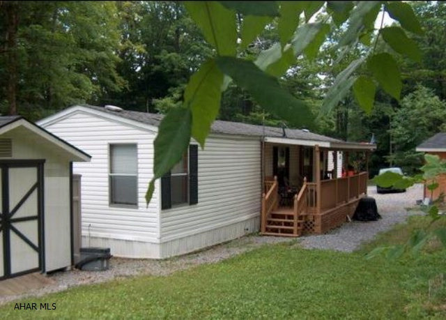 2 BR mobile home in move-in condition. Spotlessly clean w/ electric heat, gas fireplace in LR, central air, covered deck, shed & utility garage. Appliances included. Minutes from Prince Gallitzin State Park & State Game lands