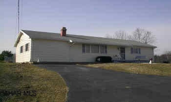 Spacious 2-3 bedroom Ranch on .7 acre.  New oak kitchen, fireplace, fenced lot, covered patio, detached garage, paved driveway, and summer room.
