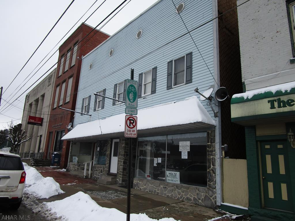 2 store fronts with garage and storage on 1st floor. Three apartments on the second floor. Apartments currently rented at $500, 500, 400. Store fronts vacant - could be 2 separate fronts. Rubber roof is 10 years old. Most windows replaced. Coal hw boiler in basement. Rewired. Separate electric.4 car parking at rear and street parking in front. Great opportunity to run your business and get income from the apartments.