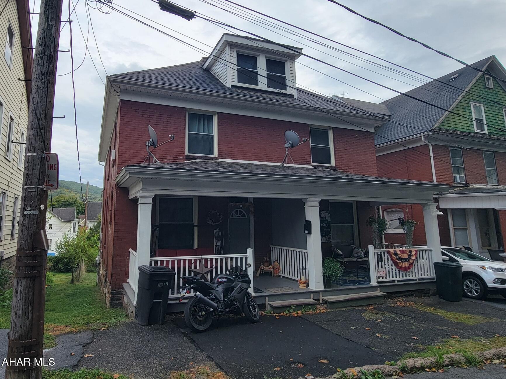 2 1/2 story, brick double house with 3 bedrooms on each side. Front and rear porches. Separate utilities. Owner pays water, sewer and trash for 1016 unit.