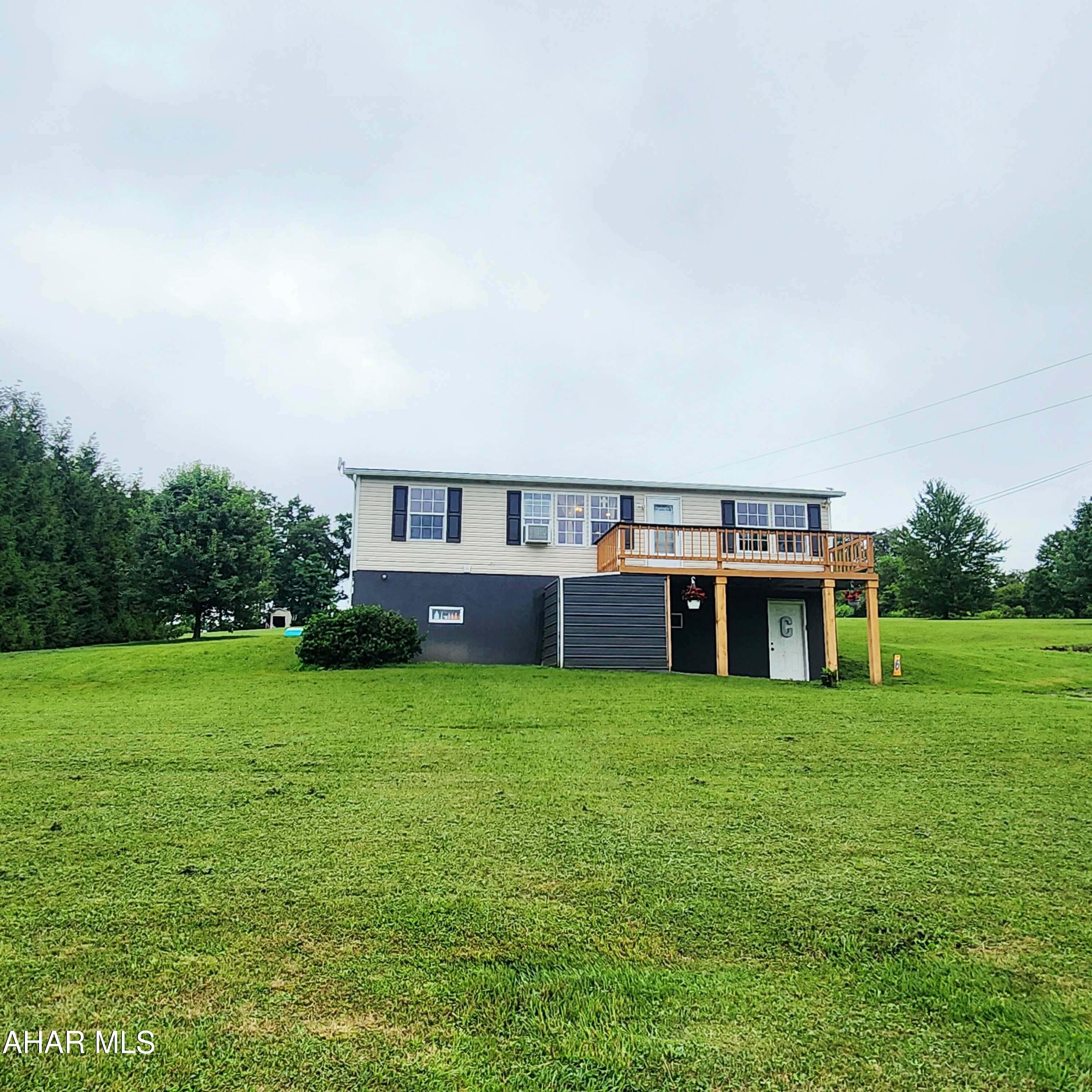 Country living at its best. This 3 bedroom 2.5 bathroom home sitting on over an acre, has undergone a beautiful remodel and is ready for a new owner. The main level offers a beautifully remodeled living room, updated eat in kitchen with pantry, main floor full bathroom, and three nice sized bedrooms.  The primary bedroom offers a large walk in closet, double sink, and private bathroom with shower. The lower level is an entertaining dream complete with large open space designable to your needs, half bathroom and bar. The lower level walks out to a built in storage area under the front deck for all your lawn care tools. The rear covered deck offers additional space for cook outs and entertaining.  The firepit area is such an added bonus for mountain pie making and smores! Call for your tour!