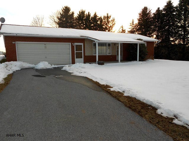 Oh-so-great country living but convenience in this full brick ranch on 1.304 acres. 3 BR, 1 full BA, hardwood floors thru out. Roof is just a few years old, newer heat pump and central air. Located right outside of Breezewood. Appliances and washer/dryer included. Paved driveway and lovely landscaping. Everett School District!