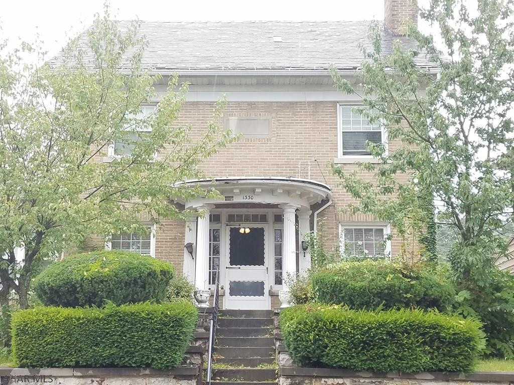 Take a step back in time with this Stately Manor on top of the hill. This home features many original charming features with some modern updates.  With 4 bedrooms and 2.5 Bathrooms, this home could easily accommodate your growing family. There is a beautiful fireplace in the main living room that makes for a great focal point, along with the gorgeous hardwood floors and beveled glass french doors.  All of the bedrooms are large with hardwood throughout, and there's an abundance of storage space.  With almost 4,000 total square feet, you will never run out of space!  There is also a large 2 car garage perfect for off-street parking.