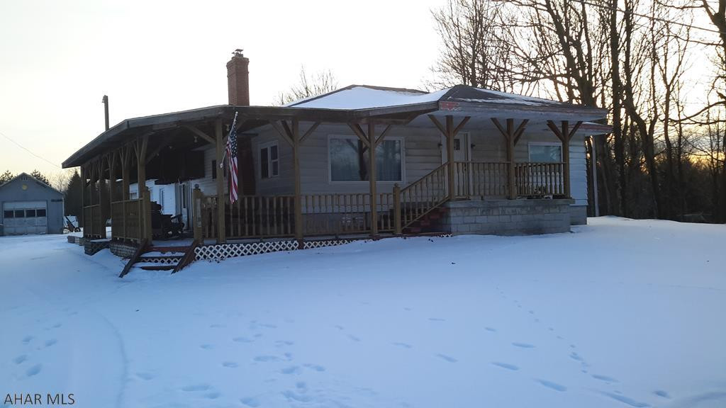 Quiet country setting for this 3 bedroom 2 bath home.Large wrap around covered deck, large 2 car attached garage. Fruit trees,blueberry bushes and grape arbor are part of this landscape.Close to Blue Knob Ski Resort & State Park. All season living to enjoy on 1.13 acres. Home boasts multiple heat sources for cozy winter nights. Well equipped eat in kitchen or sit next to fireplace in the living room. Retire to one of the 3 nice sized bedrooms. Call to make this your next home! Priced to sell!