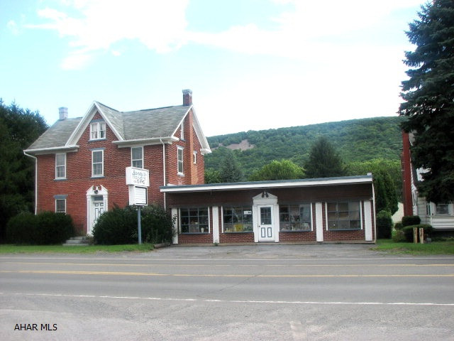 Spacious 2.5 story home & commercial store front. Currently Local floral shop and home.  Also, has 2 car garage & storage buildings. So Much to offer and a great location at an excellent price.