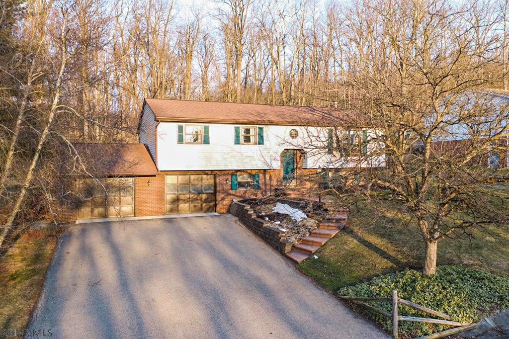 This move-in ready bi-level home is a rare find in today's real estate market.  Situated in the Rolling Hills Development of Hollidaysburg, this stunning home offers 3 bedrooms, 3 full baths, and a large 2 car garage.  The home is located at the top of the development and backs up to the woods for privacy.  The main level offers a large open kitchen with a formal dining room.  The dining room has a sliding glass door with access to the back patio.  There are three bedrooms on the main level, the master with an en-suite full bath.  There is new carpet and flooring throughout most of the main level of the the home as well.  The basement is finished and features a bathroom/laundry room, utility room, and wood burning stove.  Don't miss your opportunity to own this amazing home!
