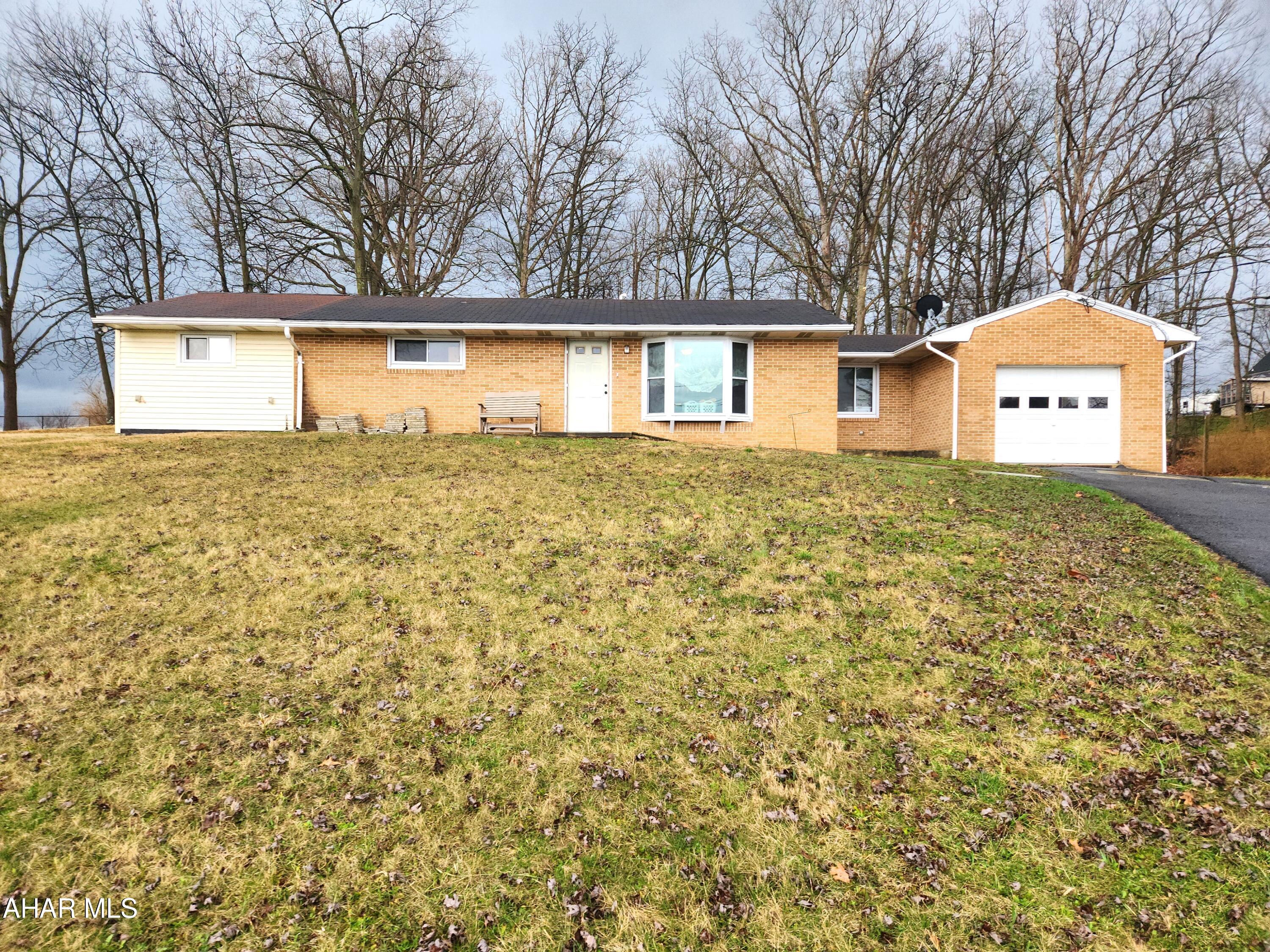 This beautifully renovated brick ranch home offers the perfect blend of comfort and countryside charm, set on a generous 0.97-acre lot in a peaceful rural setting. Inside, you'll find a spacious living rom that is an open concept to the kitchen.  Featuring plenty of hickory cabinets and a breakfast bar, the kitchen exudes functionality and style.  The large primary bedroom features newer carpeting and a large walk-in closet.  With a second bedroom, a playroom that could be a third bedroom, a full bathroom, and a convenient laundry room, this home offers one floor living that was all thoughtfully updated for modern living. With a solid slab foundation and central air conditioning, the home provides low-maintenance living and year-round comfort. 

Enjoy scenic views from the property and unwind in the spacious backyard, shaded by mature oak trees that add both beauty and privacy. The home also features an attached one-car garage for everyday convenience, along with a detached two-car garage and a separate storage shed--ideal for hobbies, tools, or extra storage needs.

Whether you're looking to buy your first home or donwsize into a manageable property with room to breathe, this move-in-ready home offers a wonderful opportunity to enjoy rural living at its best.  It's located just minutes from downtown Bedford, I-99, the PA Turnpike and Shawnee State Park.  Come have a look, it may be just what you've been looking for.  Buyer to confirm square footage and acreage.  Taxes do no reflect the Homestead Exemption.  Seller must find suitable housing.
