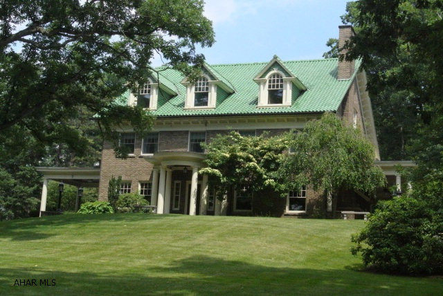 One of Blair County's finest homes...this estate boasts over 8200 sq ft of charm, quality and beauty.  Features include hardwood floors, beveled glass pocket doors and French doors that lead to an enchanting veranda (complete with tile floor and fireplace). The kitchen has been updated with a Viking stove, Sub-Zero ref and 2 prep sink areas...there is a Butler's pantry adjacent to the kitchen with hardwood floors, granite c-tops and lighted shelving for displaying glasses. The Library, Dining rooms and living room are nothing less than stunning.  Each bedroom on the 2nd floor has an en suite bath and the third level has 2 living suites...perfect for in-laws or older children. Also on the 3.2 acre lot is a stone 3 car garage with mechanic's pit and a full apartment above.