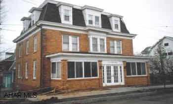 3 story brick home on corner lot. Carport & newer roof