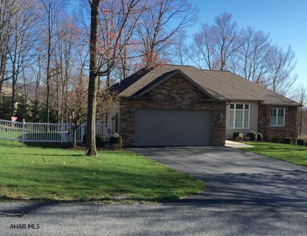 Custom built 3 bedroom, 2 full bath Greg Dempsie home in desirable Juniata Mills. Lovely stone exterior compliments the gorgeous landscaping. This is one floor living at its best! The design was built to take in nature and privacy through the many large windows. The great room has a fireplace, which is flanked by huge windows.  Tray ceilings, a wall of glass, walk in closet and en-suite bathroom make for a lovely master bedroom. A full, unfinished walk-out basement includes a 5' x 26' finished store room and sewer connection for future bathroom. Over $30K went into creating the fenced professionally landscaped yard which includes a terrace and deck that spans the entire home.