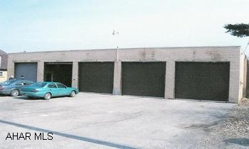 Good storage garage.  High ceilings, overhead doors, and dividing walls.  Any commerical use is subject to a variance. 78'x40' concrete block garage with five 12' overhead doors.
