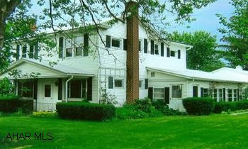 Country Farm House with 10 =/- acres. 4 large bedrooms, 2 full baths. Zoned heating, cherry paneling, fireplace with gas insert, built -in brick planters, built-in cherry cabinets in living room, large kitchen.