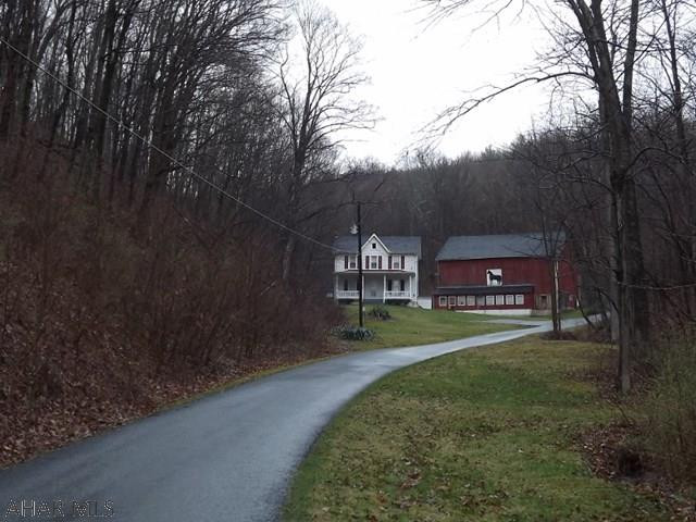 Quaint 3 bedroom, 2 bath farmhouse with a private setting and surrounded by 44 acres of woods. Formal dining room, eat-in kitchen, 2 covered porches, pocket doors, central air. Windows and storm doors replaced. 52'x42' bank barn, pavilion, stream, by Herline Covered Bridge. Area fishing, hiking, skiing and biking!