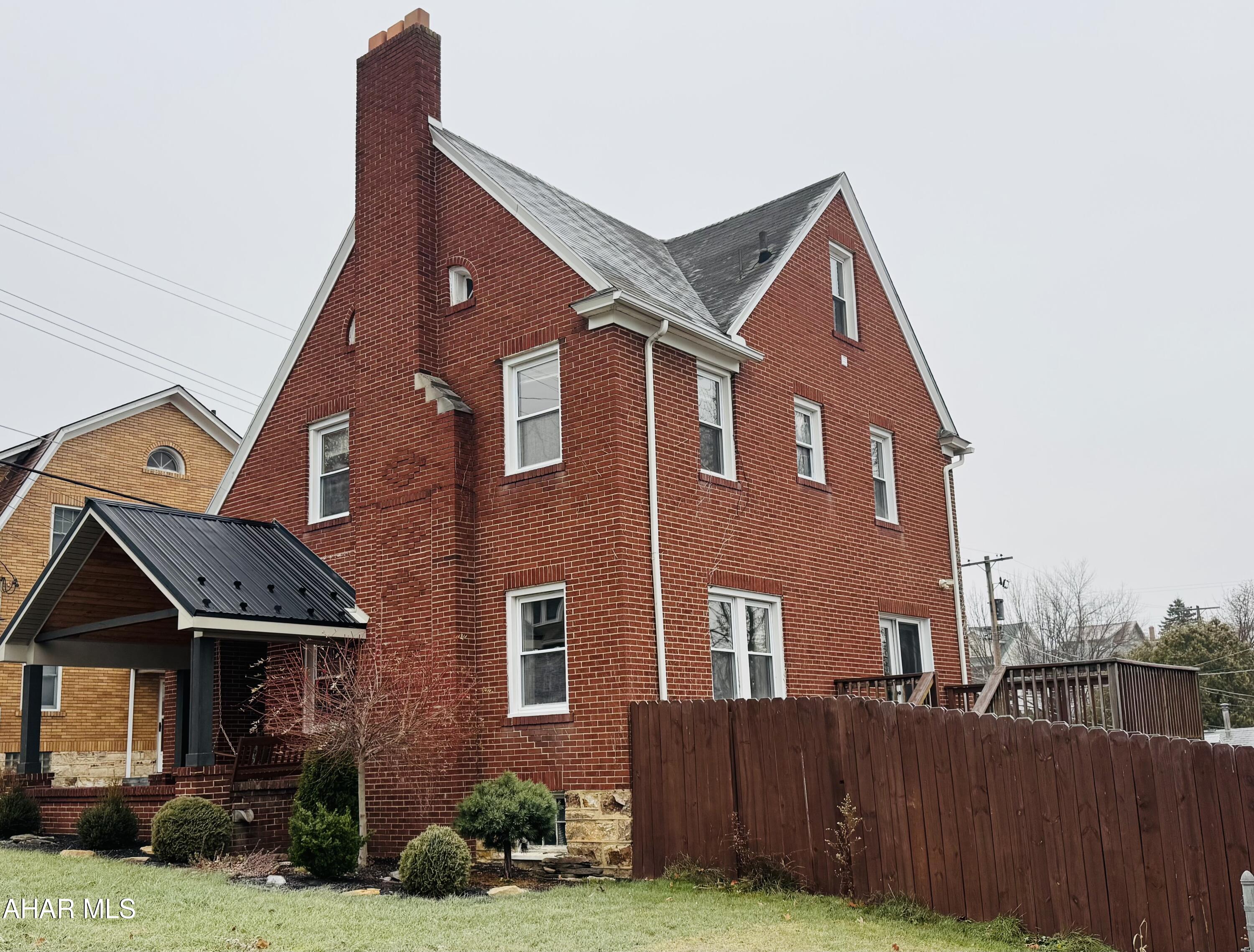 This charming brick beauty offers the perfect blend of character and charm with modern updates. Relax on the inviting covered front porch, complete with a swing and warm wood-planked ceiling that enhances the home's curb appeal.

Inside, you'll find:

3 spacious bedrooms
1.5 baths, including an updated full bath with all-new fixtures
Gorgeous hardwood flooring throughout
Large formal dining room with access to the deck
Bright and cozy breakfast nook with abundant windows—perfect for morning coffee or an indoor herb garden
Living room with a wood-burning fireplace for cozy evenings
Updated kitchen featuring quartz countertops, an island ideal for quick meals, and all appliances included The kitchen offers plenty of cabinets for all your storage needs. 
Convenient first-floor half bath for guests
Plenty of closet space
Third-floor walk-up attic, great for storage
Full basement for even more space and also provides great storage
Nice-sized deck overlooking the completely fenced lot
The attached two car garage an added plus!
Central air for year-round comfort!

This well maintained home is move-in ready and located in the desirable Calvert Hills area. Don't miss the chance to make it yours!
Call today to take a tour!