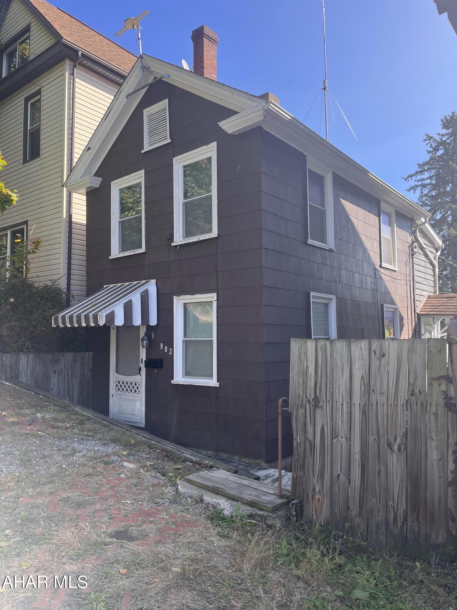 This is a small 2BR (w/bonus room) home that's perfect for 1 to 2 people. Replacement windows, newer furnace and AC.  This was set up for easy access in and out for Motorcycle use from front or rear of property with off street parking for car. Outdoor is set up as small entertaining area if desired. Needs some flooring and brightening up but overall good bones. Perfect for rental!