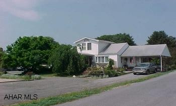 This is a Commercial site 100 x 974 - 2.24 acres across from Tractor Supply. 3 sewer taps. There is a nice 1 1/2 story home on it with a rear shop. Seller will look at all offers. Seller may consider Lease to property.