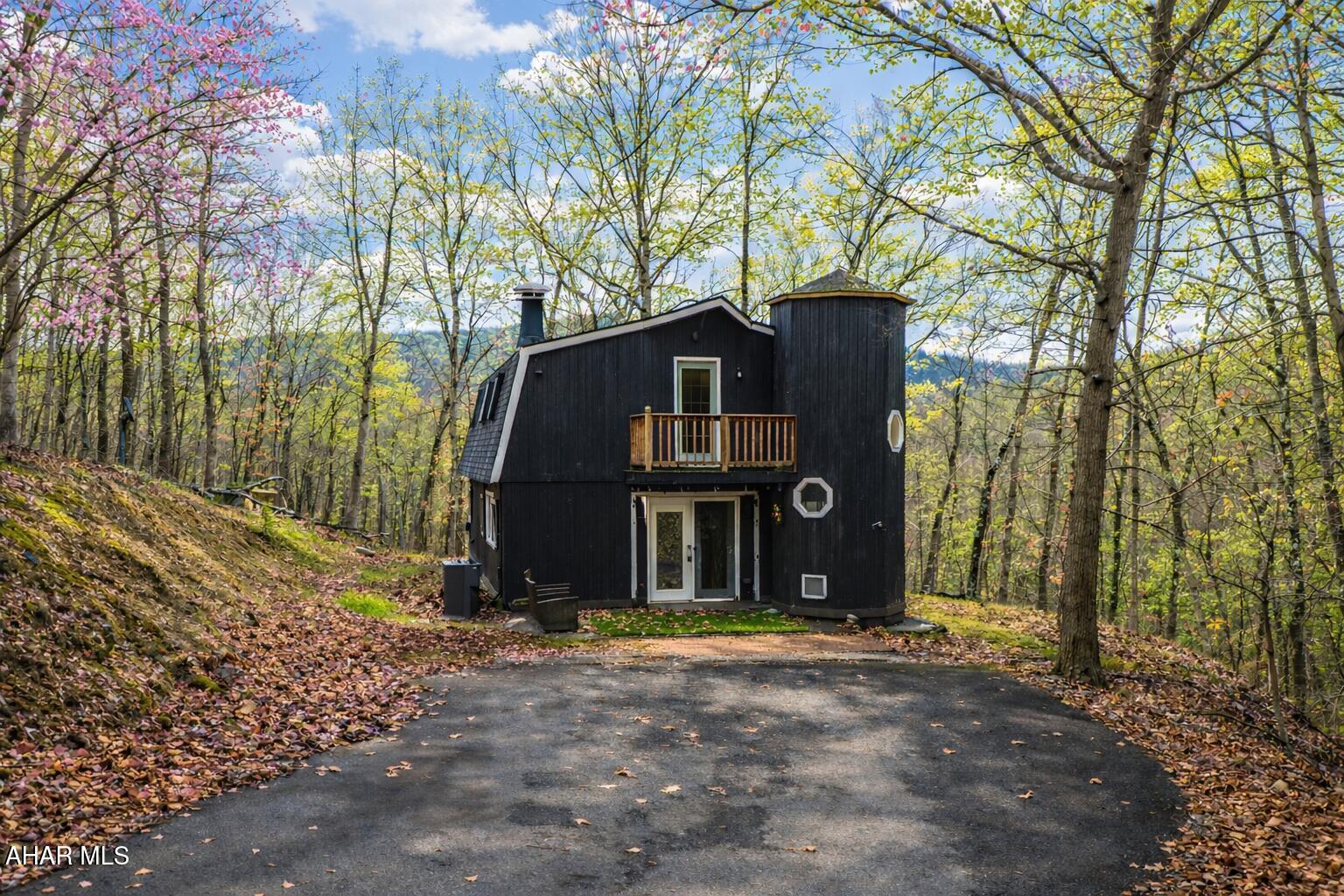 Experience custom craftsmanship paired with country living in this unique approximately 2,154 sq. ft. home. Sitting on over 10 wooded acres, this property is great for those who love outdoors. It features a cleared food plot for the avid hunter and a second-floor balcony perfect for morning coffee, tea, or protein shake while watching wildlife or soaking in the view. A set of double-entry doors welcomes you into a completely open-concept first floor, where modern luxury meets rustic charm. You'll find durable, waterproof luxury vinyl flooring throughout, beautifully complemented by warm pine wood accents.

The heart of the home is a newer kitchen--a chef's dream featuring butcher block countertops and a deep farmhouse-style sink. Bathed in natural light from two massive bay windows, the living area centers around a magnificent stone-front wood-burning fireplace, while a spiral staircase serves as a striking architectural characteristic.

Designed for modern comfort, this 3-bedroom, 2.5-bathroom home includes a private master bedroom, and updated ensuite owners bathroom that has a stand up shower. You'll enjoy total peace of mind with a new furnace and a new water heater already in place. The location is unbeatable for both convenience and leisure: situated approximately 5 minutes from the historic Jean Bonnet Tavern, 10 minutes from I-99, and only 15 minutes from the world-class Omni Bedford Springs Resort and the PA Turnpike.