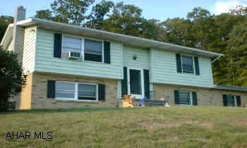 At the dead end of W. 21st Street--Right up hill One acre bi-level with private setting and great view.  Country living with city amenities.  Owner willing to help with buyer's closing costs.  Call Gene Pine for details.