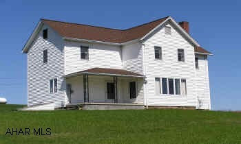 Large 2-story 5 bedroom frame farmhouse with newer siding, roof, windows and furnace on Acre +/- with good view. House overlooks 10 acres +/-  of pristine natural habitat with pleasant meandering stream which is also available for purchase.