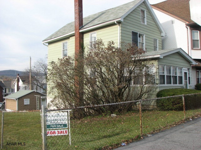 This could be a very cute house with some TLC.  Spacious, fenced, double corner lot and two car garage include off street parking.  A large enclosed front porch offers first floor laundry facilities or an additional bonus room.  Lots of storage in the dining area with the built in hutches and book cases. Hardwood under carpeting.  Includes A.H.S one year home warranty and blower motor on furnace as just replaced November 2012.