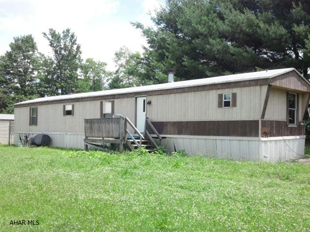 Nice lot with huge 30 x 40 commercial type garage and shed.  3 bedroom trailer has been trashed, could be renovated, but current condition is very bad.  Water and electricity is off, so owner can't even clean it out.  Take flashlight.  Sold as is.  Seller can remove mobile home if need be.  Motivated seller- bring offers!