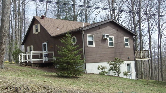 Sitting on the top of the world is where you will be both physically and emotionally when you own this gem.  More room inside and out then it looks from the outside.  Two bedrooms-including a master suite with Jacuzzi tub, 2 full baths, kitchen,LR with wood stove to take the edge off cool summer evenings or keep you toasty in the winter.  Loft adds an extra BR or bonus room.  Back deck has a great look at the woods and the deer that love to visit here.  The basement has room for a workshop and a walk out entrance for convenience. One of the few places in Glendale Yearound that you should have cell service so no land line is needed.  Gated community offers community swimming pool, tennis/basketball/volleyball courts and more.  Adjacent to Glendale Lake and near Rock Run ATV park