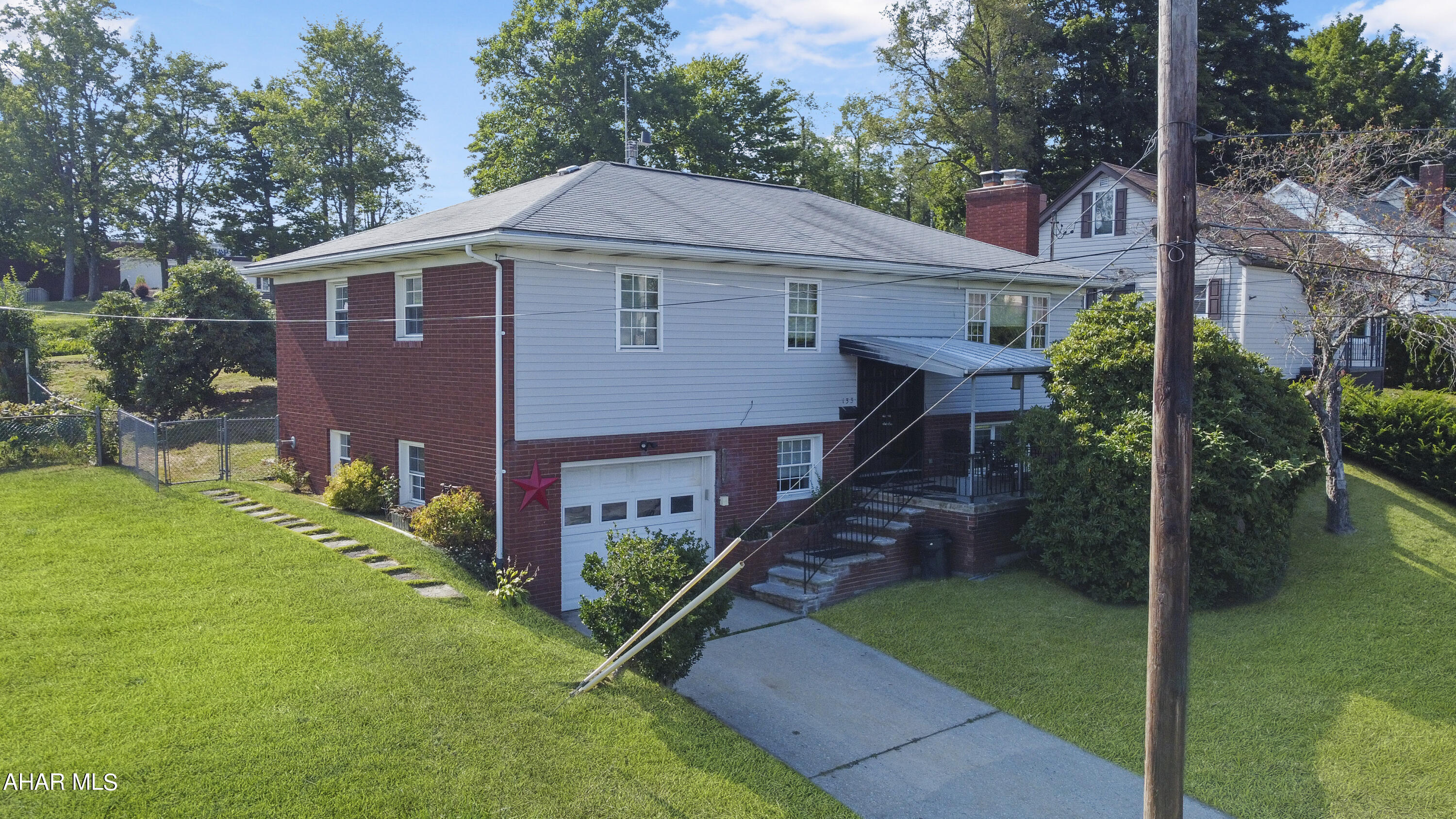 Welcome to 133 Lincoln Street in the Ebensburg Borough. This beautiful split level home borders the Bishop Carroll High School & is in excellent condition. Not only can you live in this home but you can also run your business out of it! Entering the main floor you are greeted by a spacious living area w/ a wood burning fireplace, dining area, gorgeous kitchen w/ custom cabinets, island, & included appliances. Furthermore there is a sun porch with skylights, 3 spacious bedrooms & a full bathroom. The basement is fully finished & offers a living area with another wood burning fireplace, full bath, laundry area, & a bonus room that most recently housed a salon based business. This property has central air, a partially fenced in yard, 1 car integral garage, & so much more!