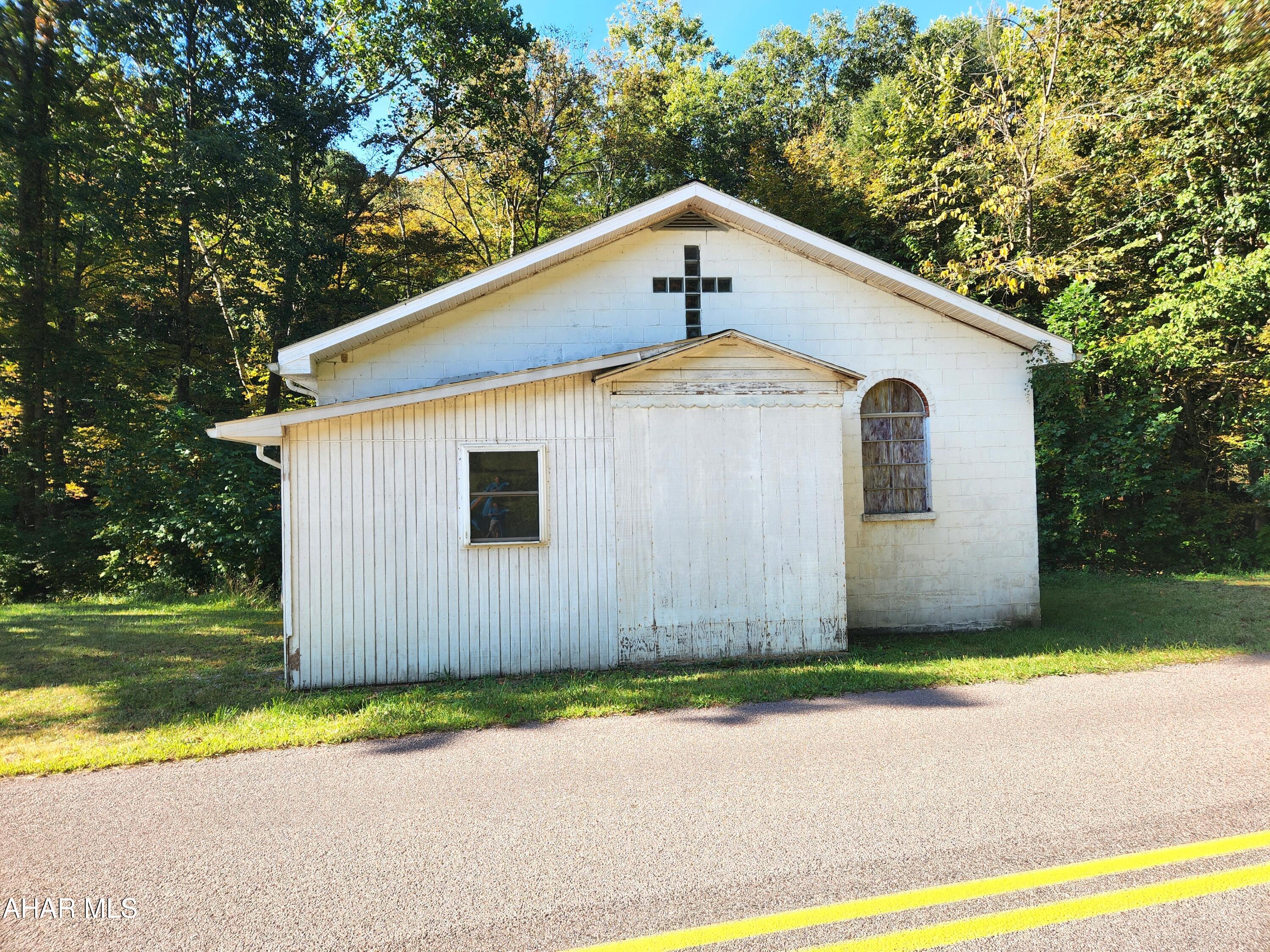 Are you looking for a storage building or a meeting place?  This large concrete block building with oak flooring could be just what you are looking for.  For years it was the home to Christian Holiness Church.  Now it is looking for a new owner to purchase it and give it a new purpose.  This sturdy buidling with an open floor plan could be used for a variety of purposes.  It has a 100 amp electrical and oil forced air heat.  There is no indoor plumbing.  With a little TLC, this could be just what you want and need.  Galddens Run, a stocked trout stream, runs behind the building.