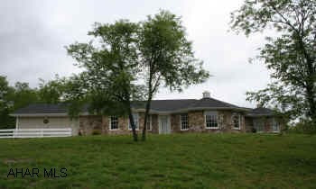 Custom stone/vinyl ranch overlooking pond. Situated on 3.79 acres; tranquil and private setting, dramatic vaulted ceilings and windows provide light and airy ambiance. Master suite has jacuzzi, shower and walk-in closets. Main level laundry, basement level has large family room w/fireplace, full bath and storage room, garage has pull-down storage above.