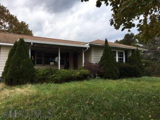 LOCATION LOCATION LOCATION!  This is a sprawling rancher in need of total renovation.  It has been abandoned and vandalized.  IT IS CASH OR RENOVATION LOAN ONLY!!!  Great views and quiet location make this quite the hidden treasure with so much potential.  There is a breezeway that connects the house and garage. Hardwood floors throughout and a basement that could be finished.  AS IS Sale Seller will make no repairs.!
