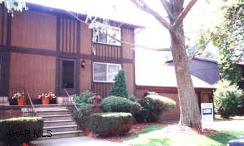 UNIQUE TOWNHOUSE WITH ATTACHED 2 CAR GARAGE WITH TREMENDOUS STORAGE ABOVE. 2 FAMILY ROOMS.
