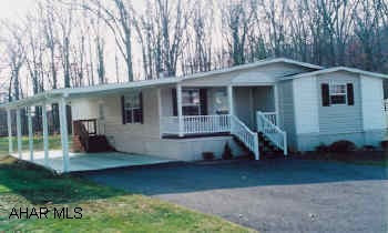 1998 Champion doublewide mobile home. 28' x 52'. On rented lot.