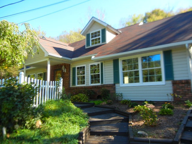 HOLLIDAYSBURG SCHOOLS...ON TOP OF THE WORLD AND SO SERENE! Awesome view from this 4 bed 2.5 bath that has been beautifully updated!  New baths and kitchen with granite, new roof, windows, central air, carpeting and flooring. 1st floor master suite enables one story living. Sun room and large family/living room with vaulted ceiling has floor to ceiling stone fireplace, skylights and tongue and groove ceiling are great for entertaining or relaxing.  The lot is over an acre and has 2 decks, a gazebo, firepit, bridge, large shed/workshop and lush landscaping. Very private and close to State Game Lands and horse riding trails!