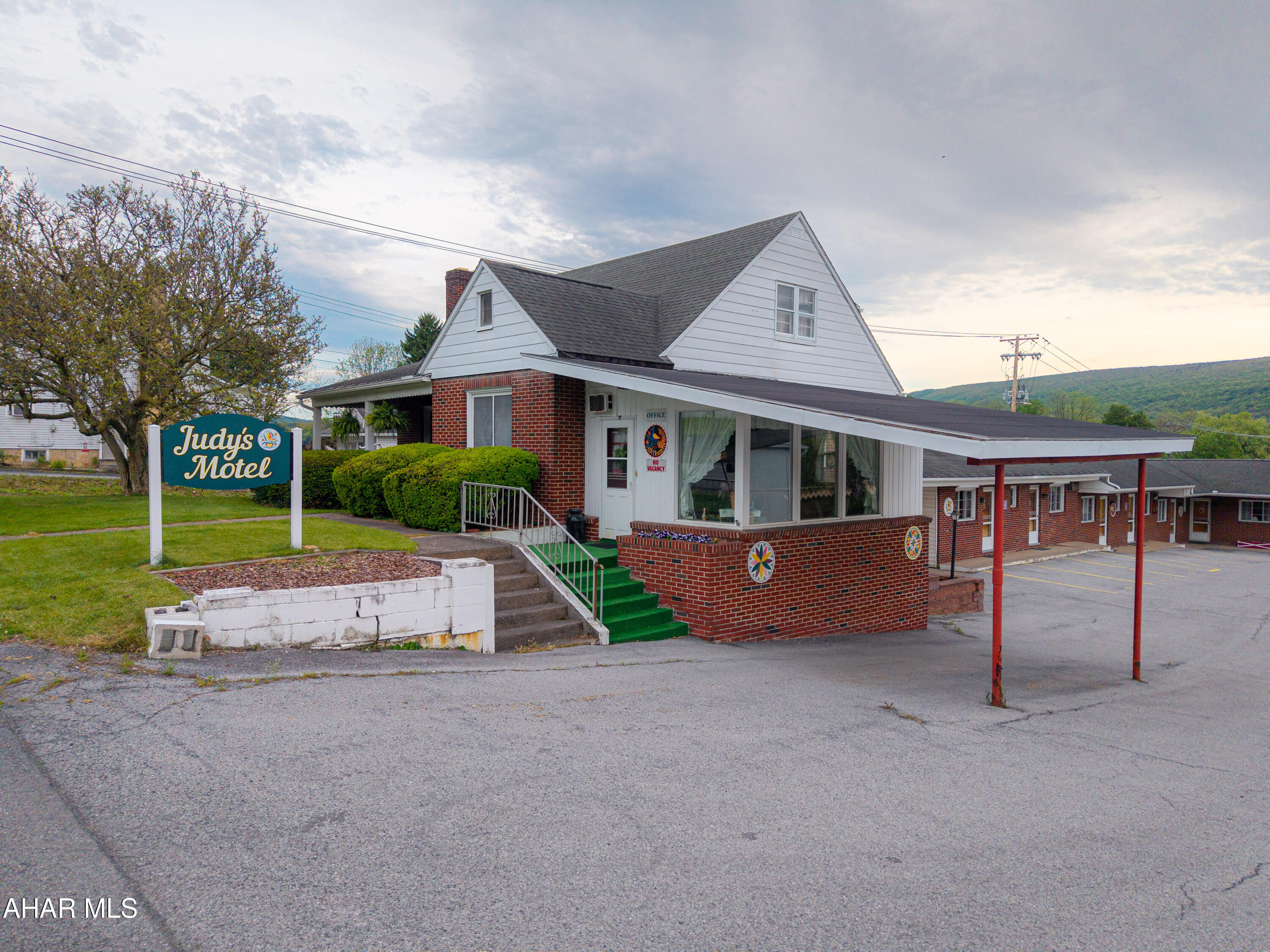 Turnkey motel business opportunity in Bedford, PA!!! This is Judy's motel and it has been in operation for approximately seven decades. Locally owned and operated by the current owner/seller for the last 38 years.  It features a 1.5-story brick home containing the motel office, a living room, kitchen, dining room, two bedrooms and a full bath on the main level. The second level has two additional bedrooms, a kitchen area, and a full bath. Full basement that is partially finished with a ground level walkout. The brick motel is separate from the house and offers twelve rooms total. Paved parking area and a corner lot with double public road frontage. Great central location along State Route 220 just outside of Historic Downtown Bedford and less than two miles to the PA Turnpike Interchange. This is a nice chance to own a small community business or could be converted into apartments or Airbnb rentals. The house could be two or three apartments/rentals, one on each level, and the motel could also covert to apartments.