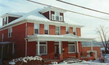 2 1/2 Story brick with attached garage. Large well maintained home with many fine features.  6 full bedrooms on 2nd floor.