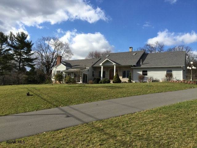 Rare find. 6 acres & close to everything! This was an older home with many updates and a huge addition. 4/5 bedrooms. 1 bedroom with fireplace could be used as an office. 2nd floor in original section is perfect for a mother in law suite. Large eat in kitchen with ceramic tile & granite counter tops. Double sided fireplace is shared with Great room. First floor family room with wood burner and first floor laundry. Large Master bedroom. 4 car attached garage and separate 2 car garage with workshop & storage above. Back patio partially covered includes built in brick oven. Above ground pool, swingset, and pond included. The main section of the basement is finished and includes a wine cellar!