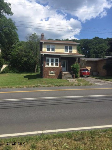 Charming brick home centrally located. Updated kitchen/bath with new tops and linenoleum flooring. Newer windows, light fixtures and carpet throughout. Hardwood floors under carpet. Private rear setting with covered porch. Alley access for off street parking.
