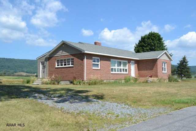 Three bedroom, 2 Bath brick ranch on a quiet and level 17 acres in Bedford School District.  Spacious home, 1500sq ft ranch, original hardwoods, Bedford County Cherry kitchen cabinets, stone fireplace, second kitchen in basement with full bath and laundry was used as an apartment. Newer 40' x 80' Metal building with 16' door and 32'x 72' 2 story barn, both with seperate water and electric.  Flat fields, mature oak trees near barns, Cove Creek less than 200yds.  Nice location for a few horses, gentleman's farm.  Call for more details.