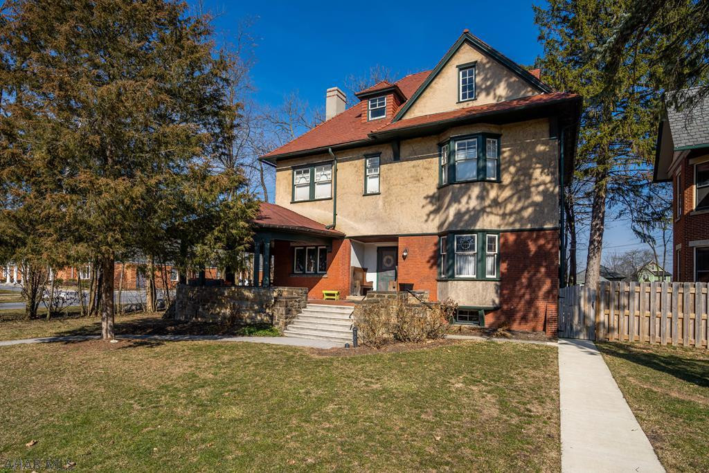 Charm and character abound in this classic brick/stucco Borough home. Features include stained glass/leaded windows, stunning wood trim, hardwood floors and a first floor laundry.  1st flr is large enough to suit all families...plenty of space for everyone. The 1st floor half bath is in the process of a make-over.  Need a home office?  There is a perfect spot headed upstairs to the 2nd floor. 4 BRs, 2 new bathrooms, all very tastefully done. Central air has been added for comfort. Walk outside and enjoy warm Summer evenings on the wrap around porch, there's also a patio area in the rear.  Walk down the sidewalk to the rear carriage house...so many possibilities. This half acre lot runs block to block...a rare find in the Borough. Of course the location is awesome...just steps to Downtown.