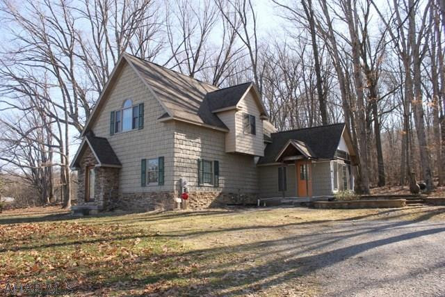 Absolutely beautiful woodwork and cathedral ceilings in this cozy home nestled on 2 private acres . The first floor has a den/office with doors to a patio.  Large laundry area and a bedroom with full bath.  There is a large room off the laundry area  that is wired and ready to make into a beautiful master bedroom and bath, or even 2 extra bedrooms. The 2nd floor has a large living area with kitchen, dining area and beamed vaulted ceilings.  Full bath and sitting nook on this floor as well.  Fantastic views from the 2nd floor. The seller put a lot of thought and love when building this home.  Call the listing agent today for your private showing!