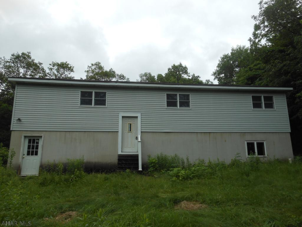 This property is a split entry home located in Kimmel Township on Country Acres Estates Rd. This property has 3 acres along with a private well and septic. There is a 2+ car detached garage with a loft that flows into a patio at the rear of the house. The house has a very convenient 2 car integral garage. The basement is unfinished, but has a laundry room, utility room and family room that just need some finishing touches to make living space. The main floor features a living room, eat in kitchen, full bath, three bedrooms including a master bedroom and master 3/4 bath. Nice private setting with storage ready to go. With some customization, this house could be your home.