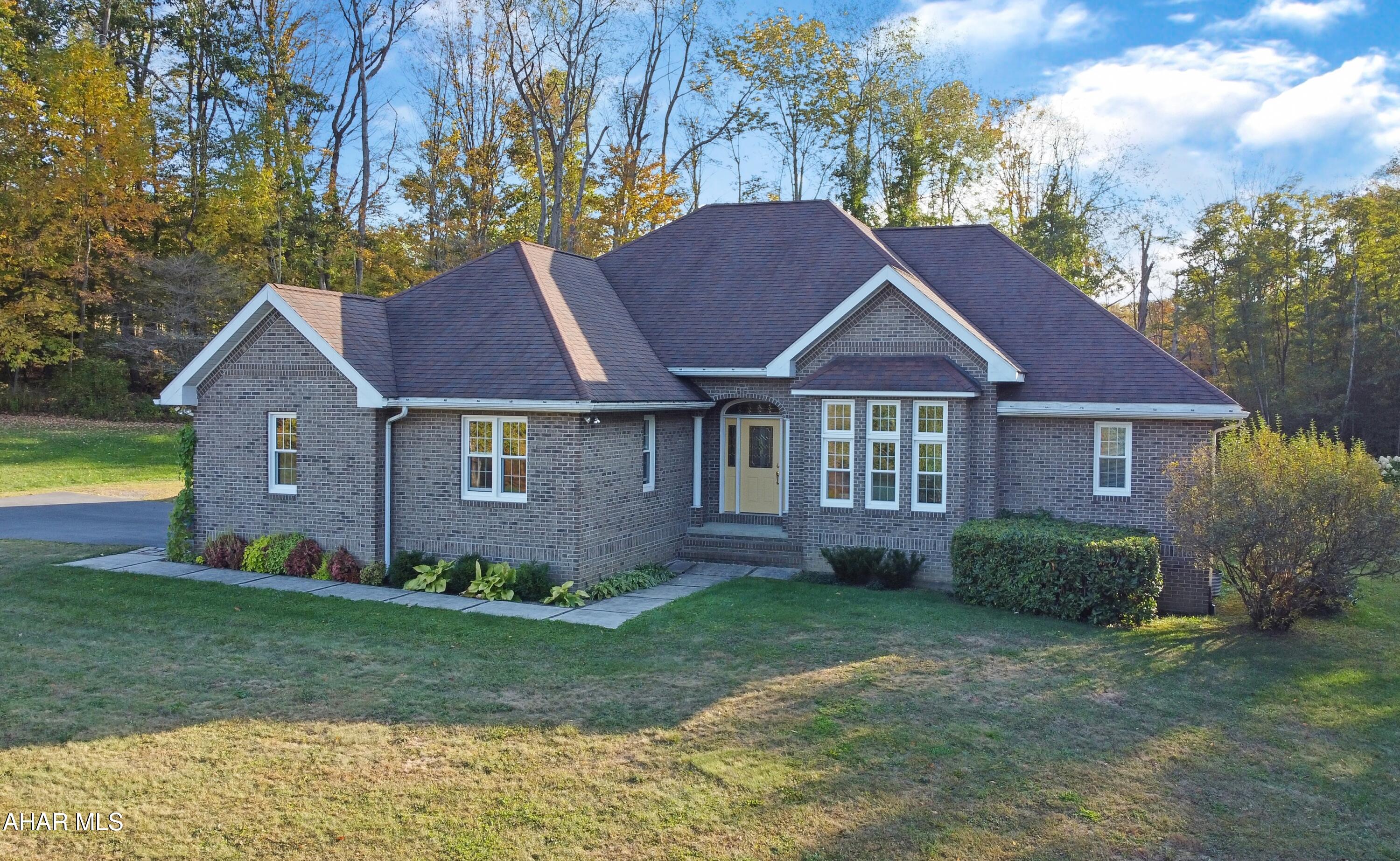 Welcome to 912 Brick Road, a private 13-acre estate in Loretto where timeless craftsmanship meets modern comfort. This custom-built all-brick home showcases meticulous care & exquisite details throughout, from its grand foyer & soaring vaulted ceilings to the elegant hardwood floors & custom trim. The main level offers a stunning formal living & dining room, a cozy family room w/ a wood-burning fireplace, a chef's kitchen w/ a generous island, a luxurious master suite w/ a spa-inspired bathroom & walk-in closet, & two additional bedrooms w/ a stylish Jack & Jill bath. Recent upgrades include a new roof, windows, & furnace for peace of mind. The expansive basement & walk-up attic offer endless potential for additional living space, while outside, you'll find a covered patio, a flat backyard w/ sweeping views, a two-car garage, & a spacious steel building—all surrounded by rolling hills & serene privacy. This exceptional property is a rare find. Schedule your private showing today!