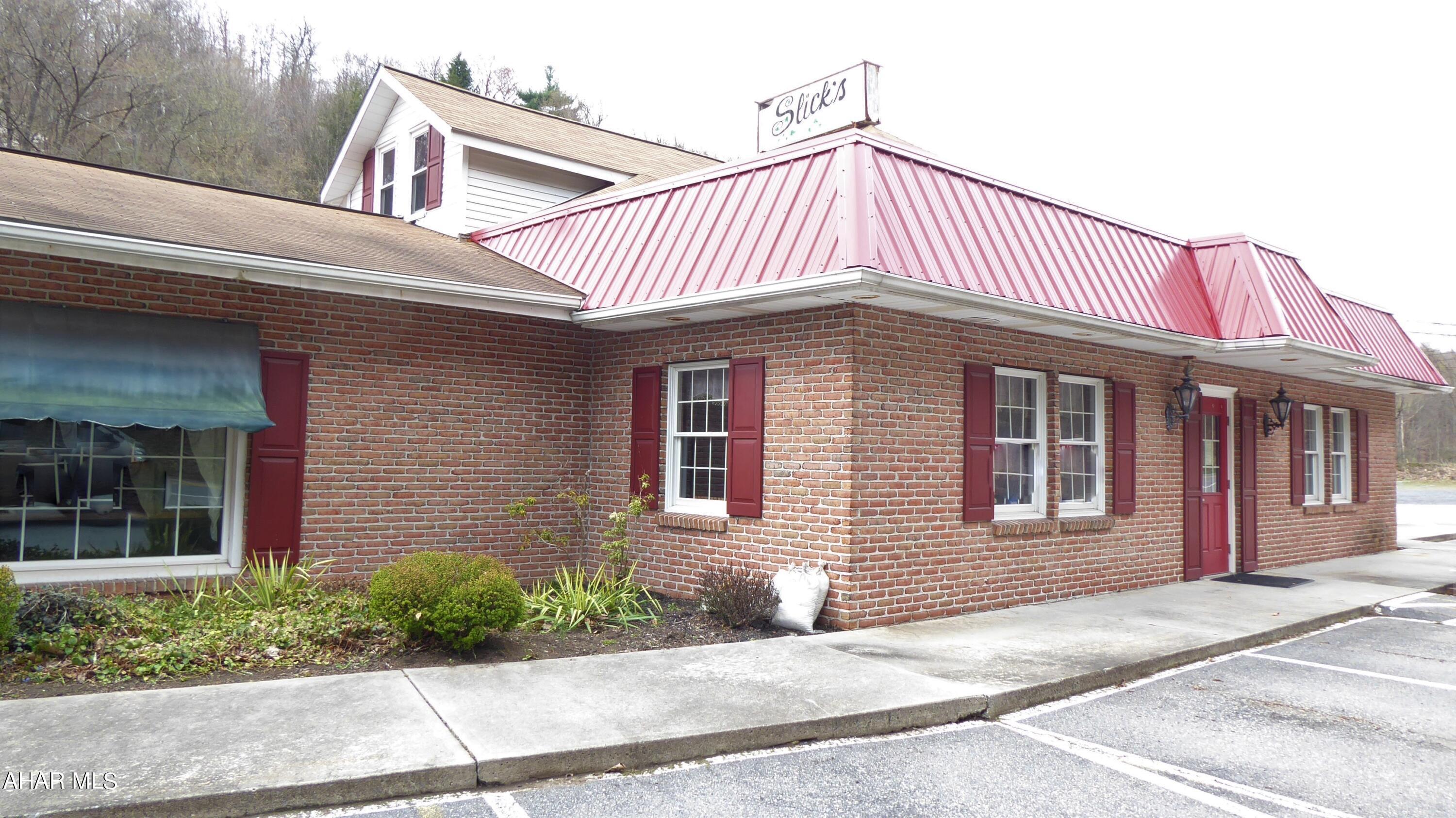 9,000+ square foot commercial building previously a family owned restaurant.  This unique building comes with a banquet/conference room seating 200+.  Large commercial kitchen with all equipment to run a restaurant, additional rooms for retail or office space.  Second floor has additional office space, storage, or could be converted into an apartment.  Ample off street parking.  Possibilities are endless.