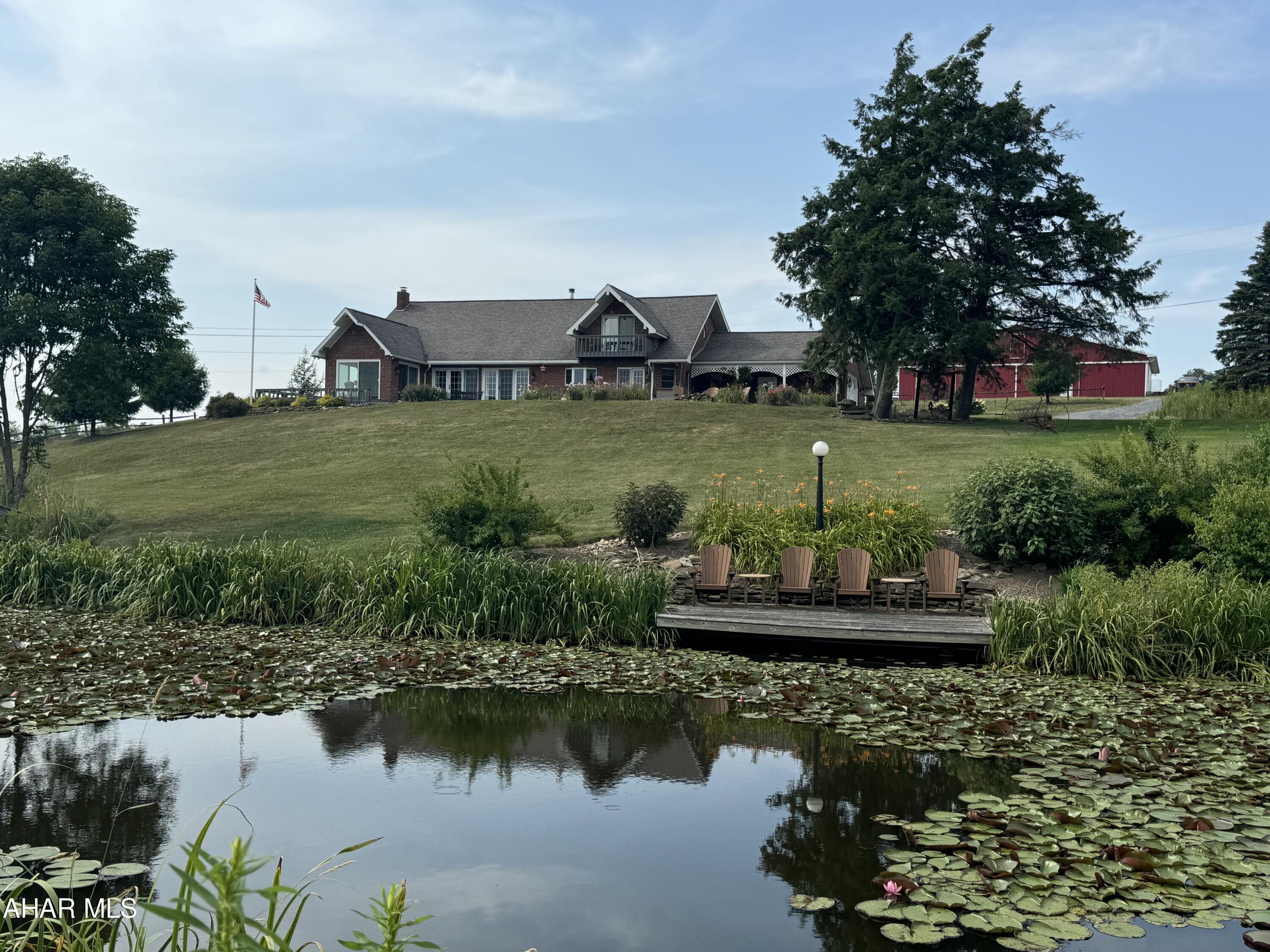 Welcome to this fabulous, serene property that will leave you breathless. This property has it all. Beautiful brick home, cabin, 2 barns, 2 ponds, 127+ acres and a dock to fish!! 
Where to start? Once you take a step into this gorgeous home you will not want to leave. The kitchen has custom cabinetry, slate floors and quartz countertops. The DR/LR has vaulted ceilings with beams from an old 18th century home! Enjoy the warmth from the brick fireplace in the winter or sit out in the 3 season room and enjoy the peacefulness and views. Home has 4 BR with one that can be used as a den, office or a 5th BR. Finish the basement for even more space! Possibilities are endless!
Take a walk to the cabin on the property as its quite stunning. Have family, friends stay in their own space or rent out to students as the University is close!! Cabin has its own wood stove, kitchen, 3BR and a claw tub!
The 2 barns on the property were restored and in great condition.
Love to fish? Take the pontoon boat out or stay on the dock. Dock has running water, bathroom, a bed and there are lots of large fish! Large pond is roughly 15'.
If you are looking for a property that has it all, look no further. This is it!
OGM is being sold with property.
Call listing agent ASAP for your tour!